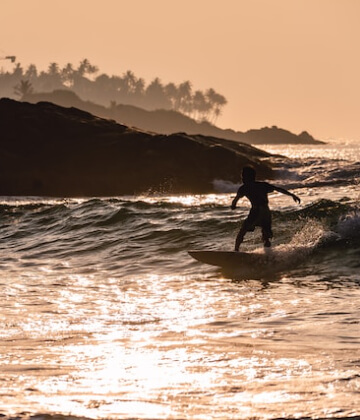 Surfer on a wave at Mirissa beach, Sri Lanka