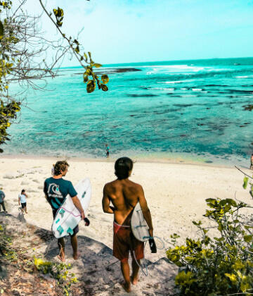 Surfers at Marga beach, Bali, Indonesia