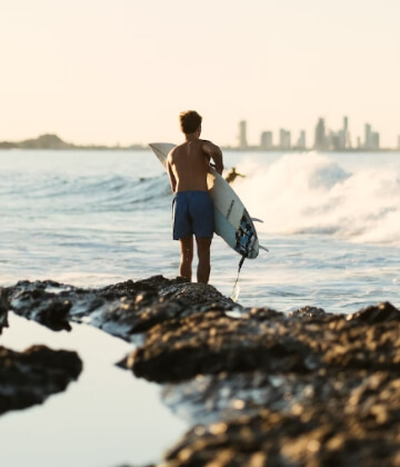 Surfer getting ready to jump in the water at the Gold Coast, Australia