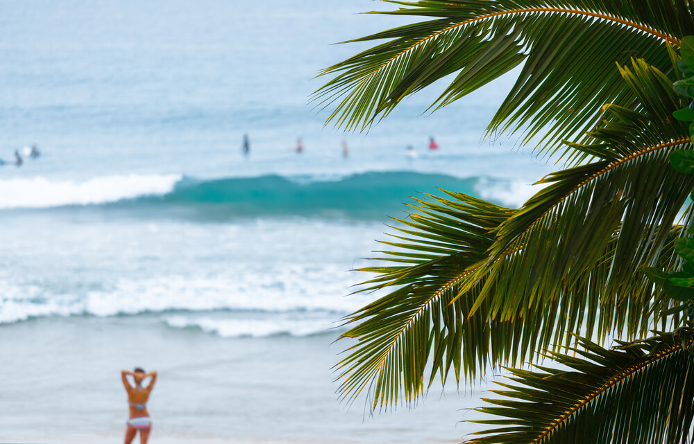 Ocean view of people in the water and on the beach