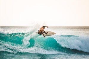 Professional-surfer-on-a-white-surfboard-riding-the-wave