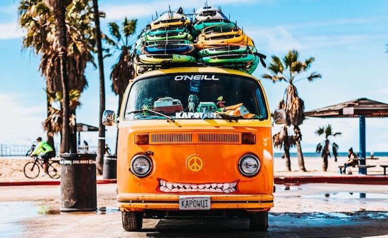 A surf van with lots of boards 