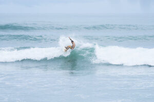 Surfer riding a wave at Punta Arenas, Costa Rica