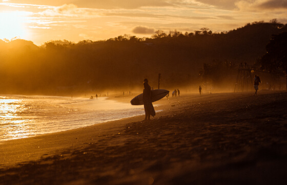 Surfer at the beach during the sunset in Panama