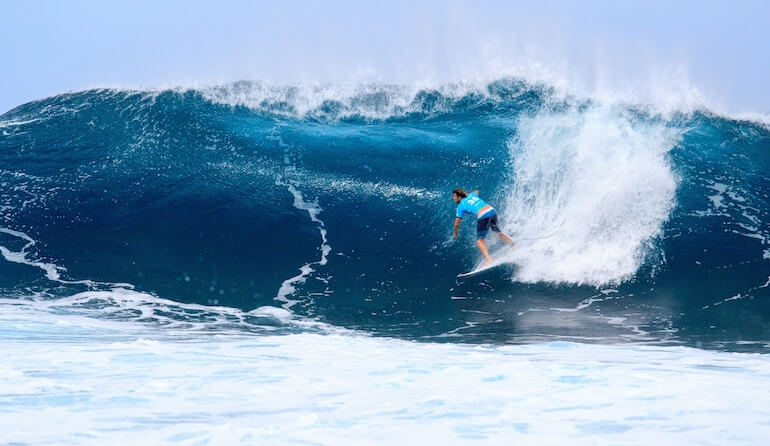 Surfer catching a huge wave