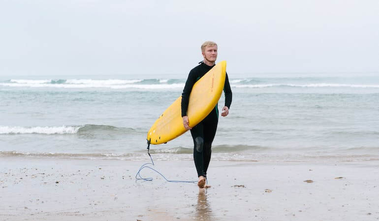 A guy with a soft surfboard 