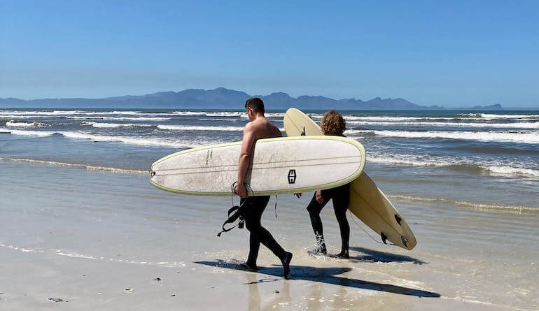 A pair of friends surfing together 