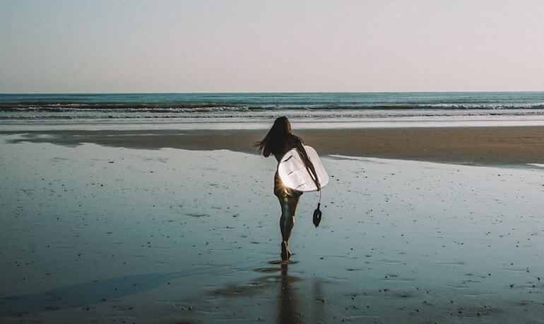 Surfer alone on the beach