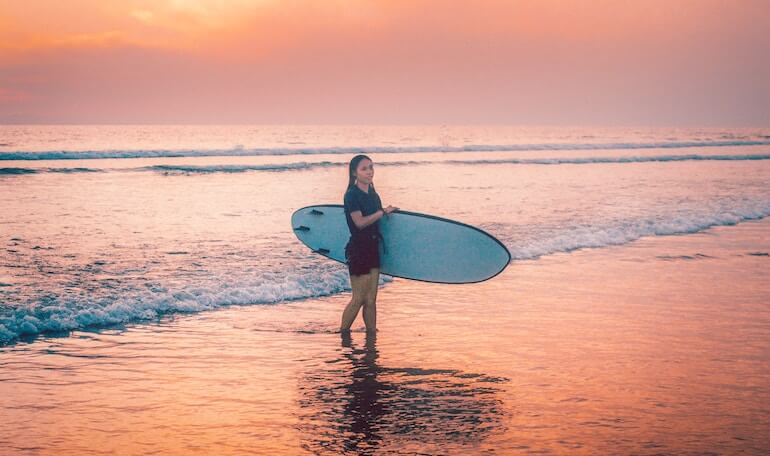 Surfer girl on the beach 