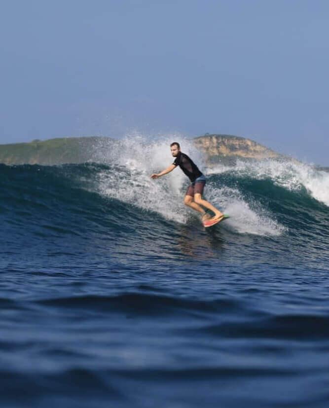 Surfer Jonatan Ailert surfing a wave in lombok, indonesia