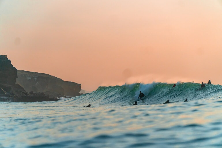 Surfer catching a wave in Ericeira, Portugal