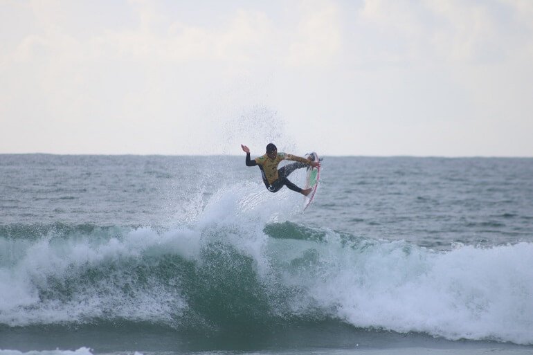 Surfer performing an air in Peniche, Portugal