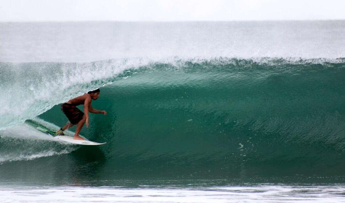 man surfing under the wave