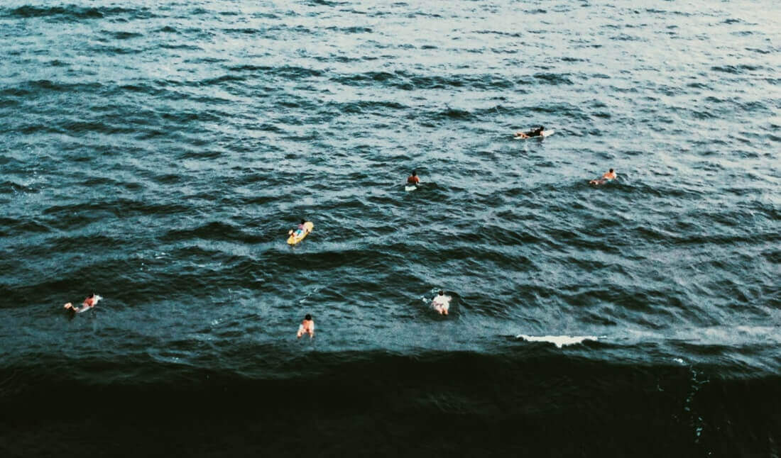 people surfboarding in the sea