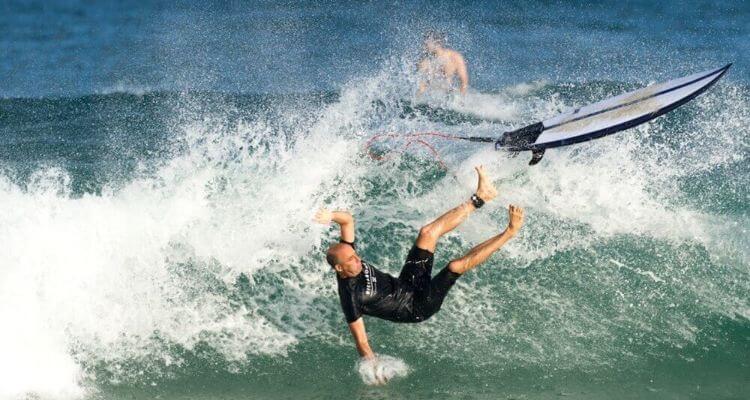 A-man-falling-off-his-board-while-surfing (1)