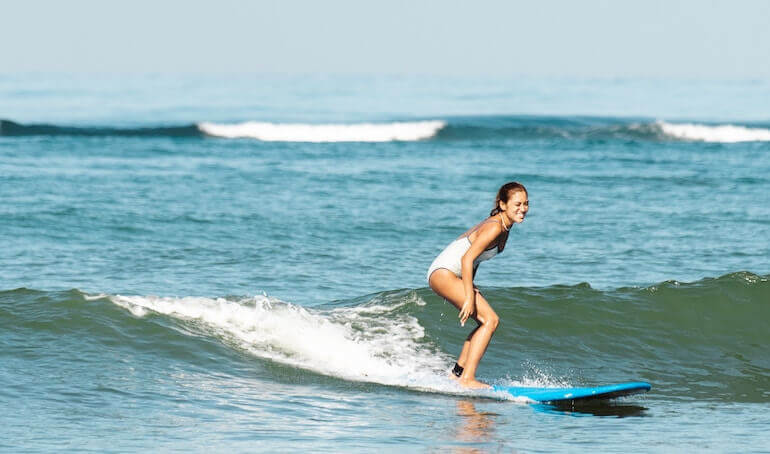 Girl catching a small wave 