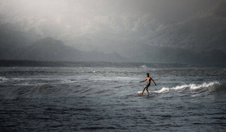 Surfer alone in the wilderness 