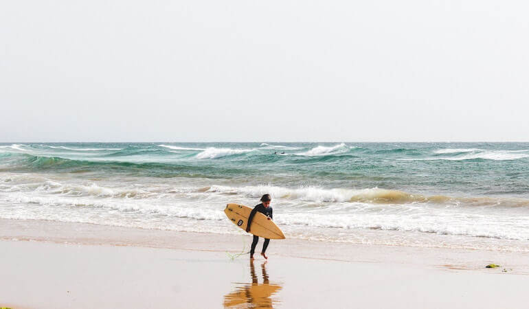 Surfer on the beach in Morocco 