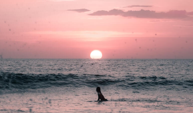 Surfer watching the sunset 