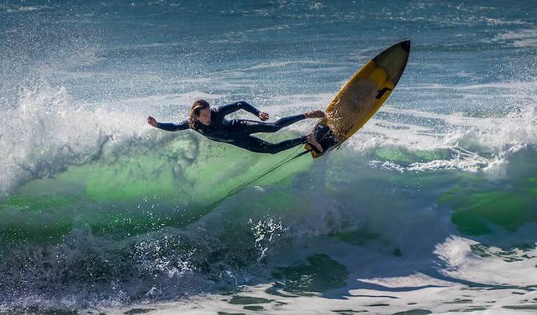 A surfer attempting an air 