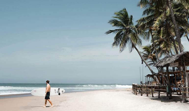 Surfer walking on the beach