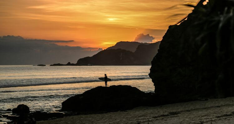 Surfer on the beach in Lombok