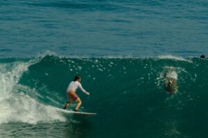 Surfer riding a wave on Uluwati, Bali (Indonesia)