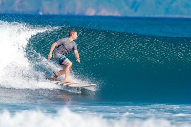 Surfer riding a wave in a surfcamp in Bali