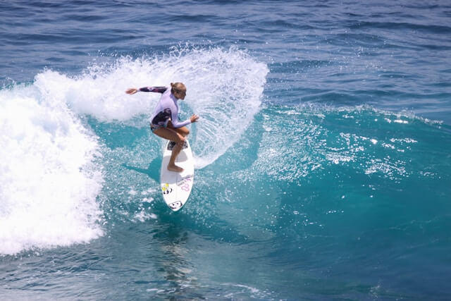 Surfer girl ripping a wave in Uluwatu, Bali