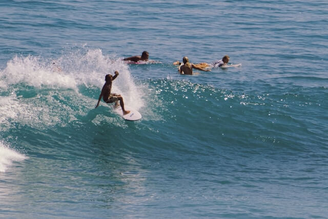 Surfer riding a wave in Pecatu, Bali