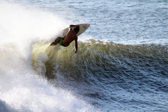 Surfer riding a wave in Sumatra