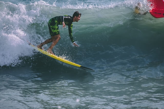 Intermediate surfer with a softboard in Bali