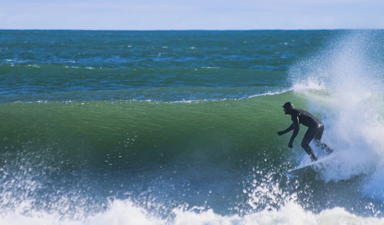 A surfer in a thick wet-suit