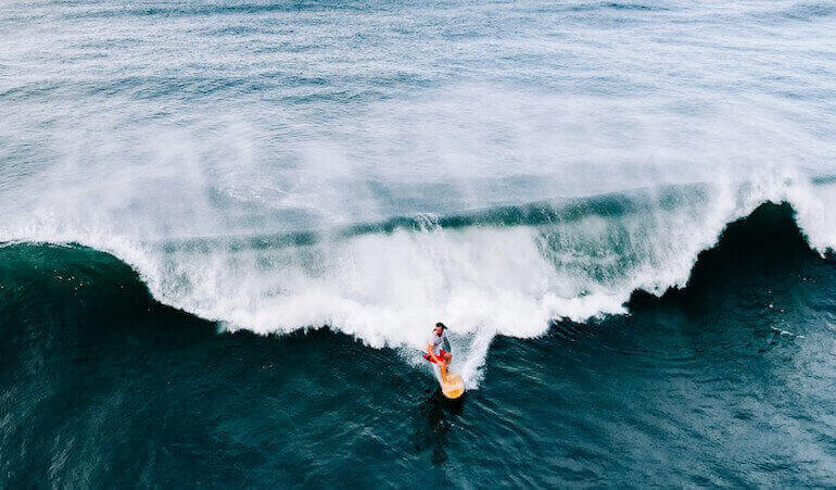 Surfer alone on a wave