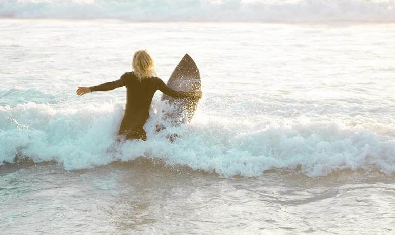 Surfer entering the ocean