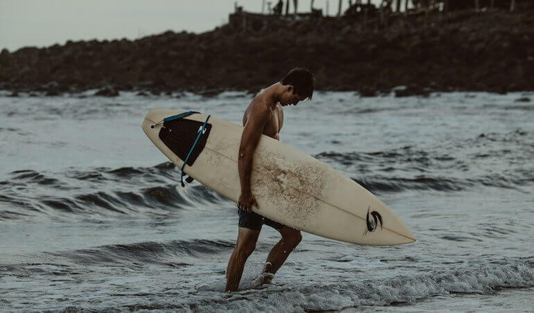 Guy alone at a surf break 